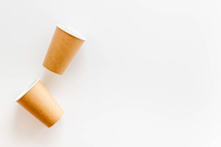 Empty paper cups for coffee to-go from cafe on white background top view mock upの写真素材