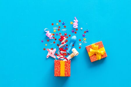 Box filled with party objects on blue background top viewの写真素材