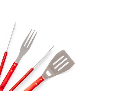 Tongs, fork, spatula for barbecue and grill on white background top view space for textの写真素材