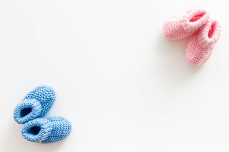 Cute baby booties for girl and boy on white background top view copyspaceの写真素材