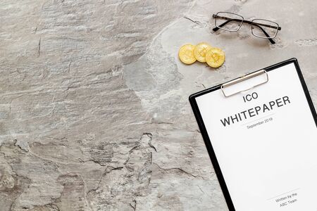 White paper ICO, coins, glasses on gray textured background top view mockupの写真素材