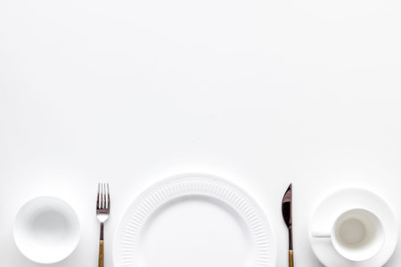 White plates and cup for table setting on white background top view mockup