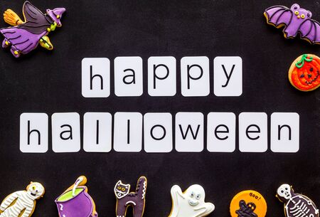 Happy halloween copy and cookies for decoration on black background top viewの写真素材