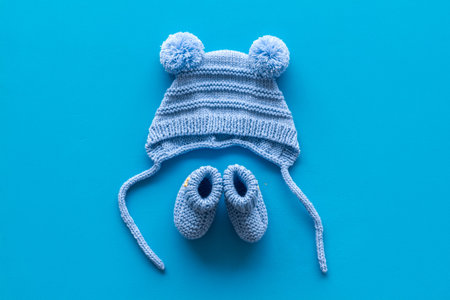 Cute baby clothes for boy on blue background top view
