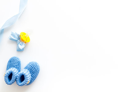 Cute baby clothes for boy and dummy on white background top view copyspace