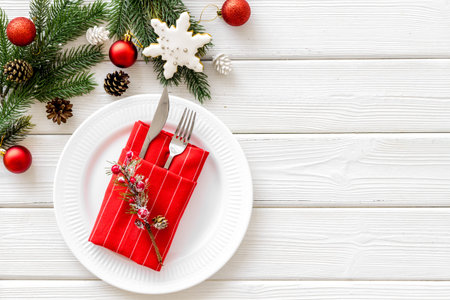 Christmas table setting with fir tree and toys on white wooden background top view space for text