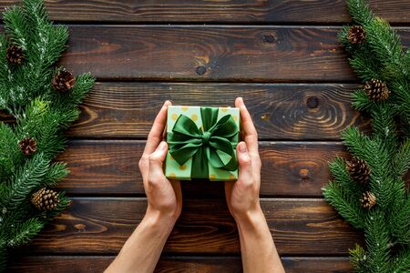 new year party preparation frame with gifts and hands on wooden background top veiwの写真素材