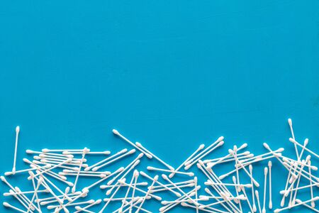 Cotton swabs for blog design on blue background top view space for textの写真素材