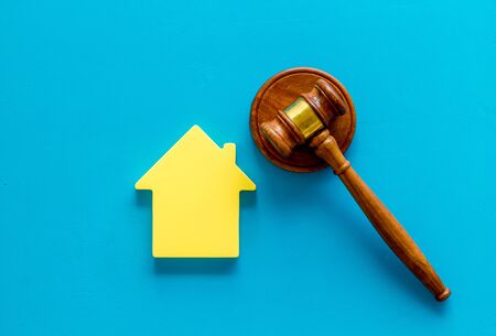 Inscribed gavel, house figure for inheritance concept on blue background top viewの写真素材