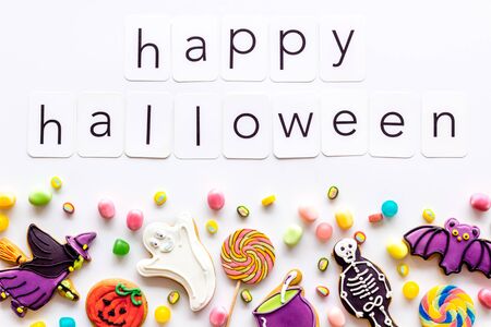 Halloween cookies frame in shape of spooky figures with happy halloween copy on white background top viewの写真素材