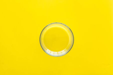 Empty bowl on yellow background top viewの写真素材