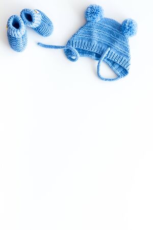 Booties and hat for newborn boy on white background top view mockupの写真素材