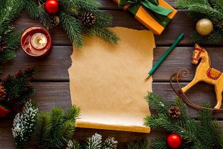Letter to Santa Claus concept. Paper on dark wooden background with New Year decoration top view mockup copy spaceの写真素材