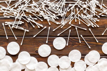 Hygiene and cosmetic. Pattern from cotton pads and swabs on wooden background top viewの写真素材