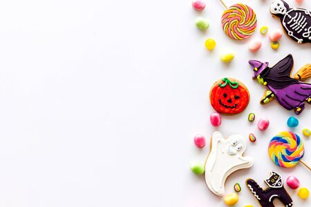 Celebration halloween and party decorations. Creepy cookies for halloween treat frame on white background top view space for textの写真素材