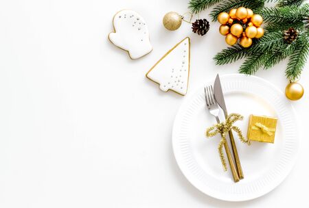 Christmas table setting with fir tree and gift in box on white background top view space for textの写真素材