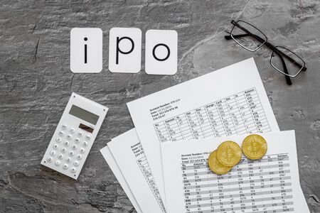 IPO with coins and calculation table on office desk gray textured background top viewの写真素材
