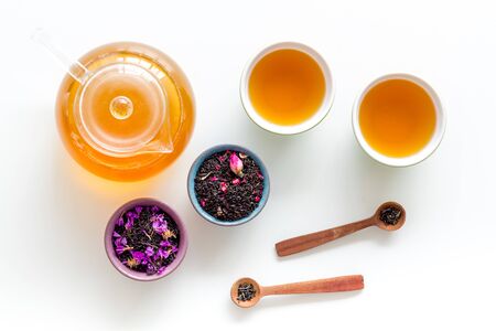 Tea brewing with dry leaves on white background top viewの写真素材