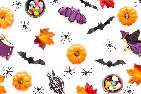 Nice halloween background with sweets. Cookies and pumpkins on white top view.の写真素材