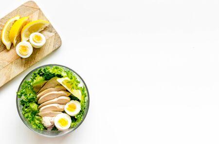 Salad bowl with healthy food for lunch at work place on white background top view copyspaceの写真素材