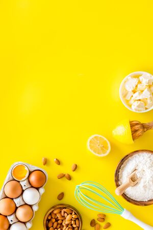 Baking background. Dough ingredients on yellow background top view space for textの写真素材