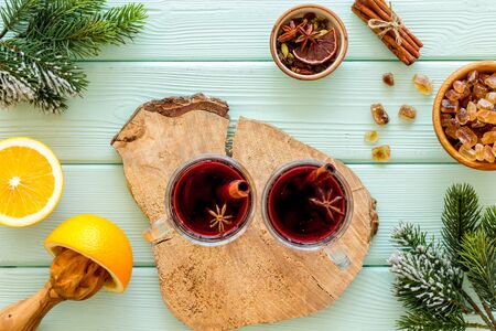New Year composition with mulled wine and fir branches on green wooden background top viewの写真素材