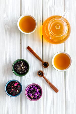 Cups, teapot, dry tea on white background top view patternの写真素材