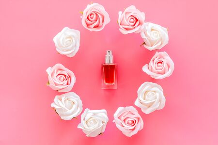 Perfume and roses composition on pink background top view pattern frame.の写真素材
