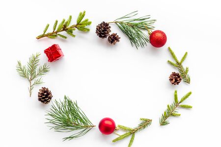 New Year decorative mockup. Fir branches and festive toys frame on white background top view.の写真素材
