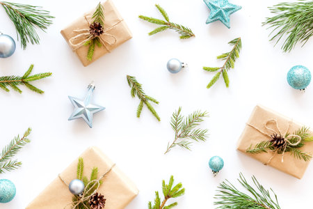 New Year background with fir branches and festive decoration on white table top view flat lay...