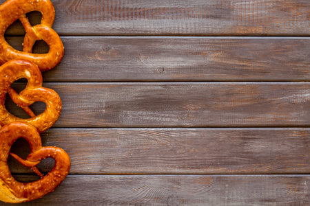 Pretzels frame, dark wooden background top view space for text