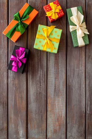 gifts frame on wooden background top view mock up
