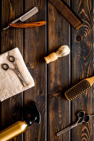 Mens hairdressing tools on dark wooden background top view flat layの写真素材