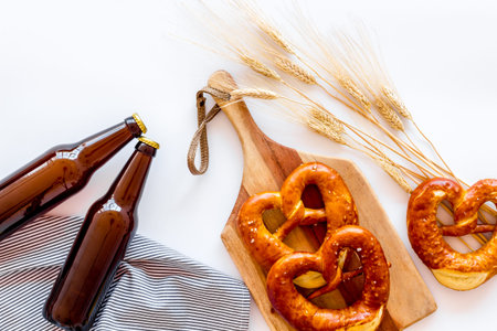 Octoberfest background. Pretzels and beer on white background top view