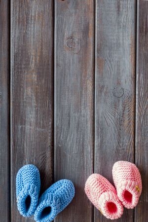 Booties for newborn boy and girl on wooden background top view mockupの写真素材