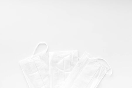 Flu prevention concept. Medical face mask on white background top view space for textの写真素材