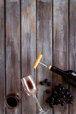 Red wine bottle near wineglass on dark wooden background top view copy spaceの写真素材