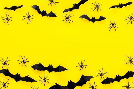 Stylish Halloween design. Bats and spiders on yellow background top view.の写真素材