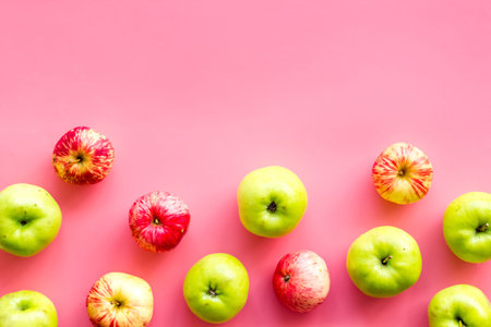 Autumn composition with fresh apples on pink background top view.の写真素材
