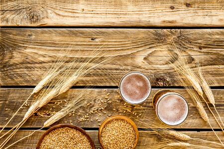Beer ingredients. Barley near beer glasses on rustic wooden background top view copy spaceの写真素材