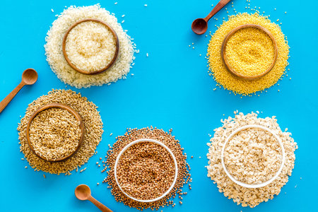Healthy food concept. Cereals in bowls on blue background top view