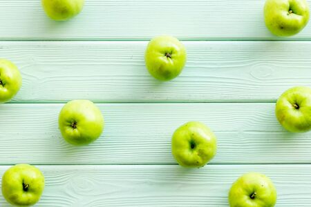 Green apples pattern on green wooden background top viewの写真素材