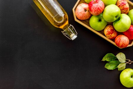Vinegar made from fresh apple on black background top view copy spaceの写真素材
