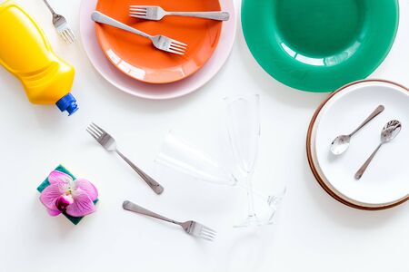 Washing dishes concept. Plates, spoons, forks on white background top view copy spaceの写真素材