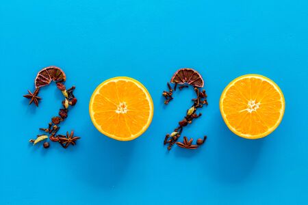 2020 New Year card lined with mulled wine ingredients on blue background top view.の写真素材