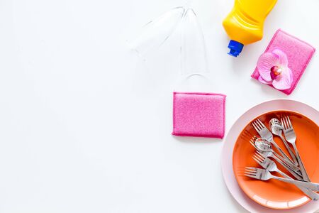 Washing dishes frame with plates, sponges, dishwashing liquid on white background top view.の写真素材