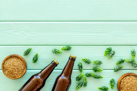Barley and hop for making beer on green wooden background top view copy spaceの写真素材