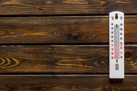Weather thermometer on dark wooden background top view copy spaceの写真素材