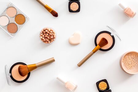 Makeup set with powder, rouge and brusheson white background top view patternの写真素材