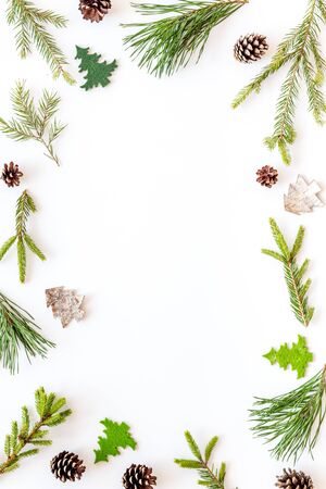 New Year decorative mockup. Fir branches and festive toys frame on white background top view copy spaceの写真素材